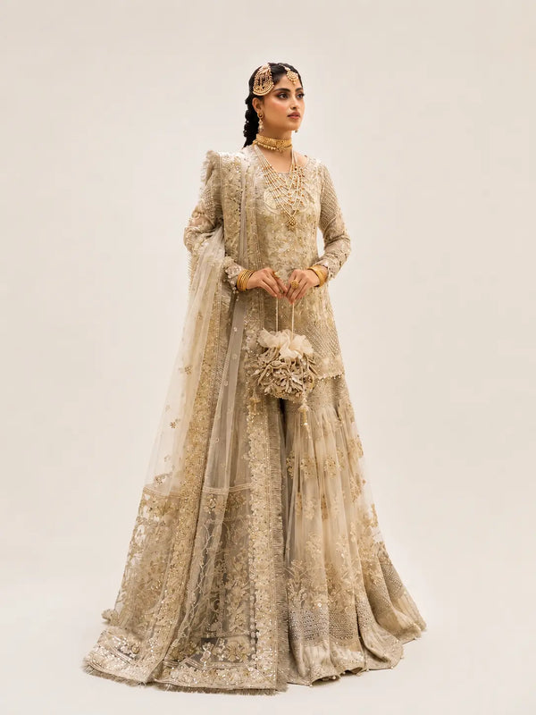 Ivory gharara with short shirt from faiza saqlain brand with beige background.