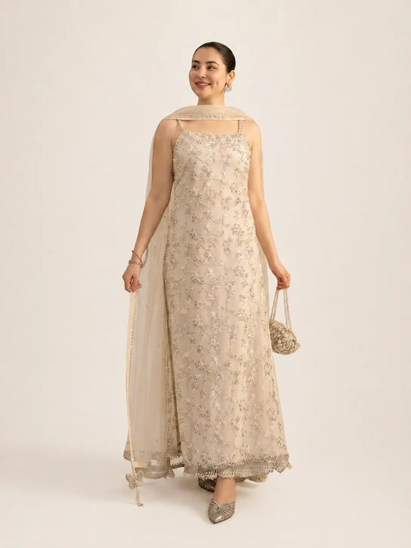 Ivory long shirt from faiza saqlain brand with beige background.