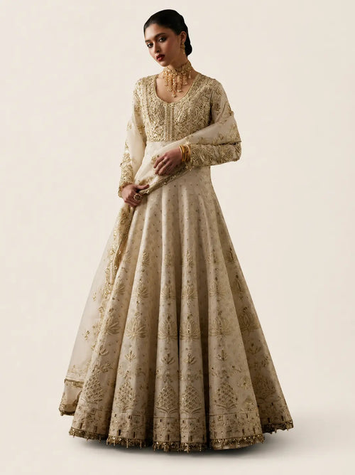 White Maxi with Lehenga in organza fabric with plain beige background.